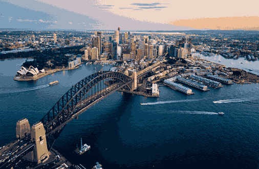 a bridge over water with a city in the background